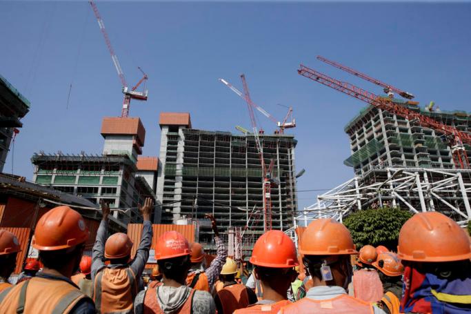 Workers gather outside a construction site as they protest to demand recognition of their labour rights at the downtown area in Yangon, Myanmar, 19 January 2021. Photo: Lynn Bo Bo/EPA