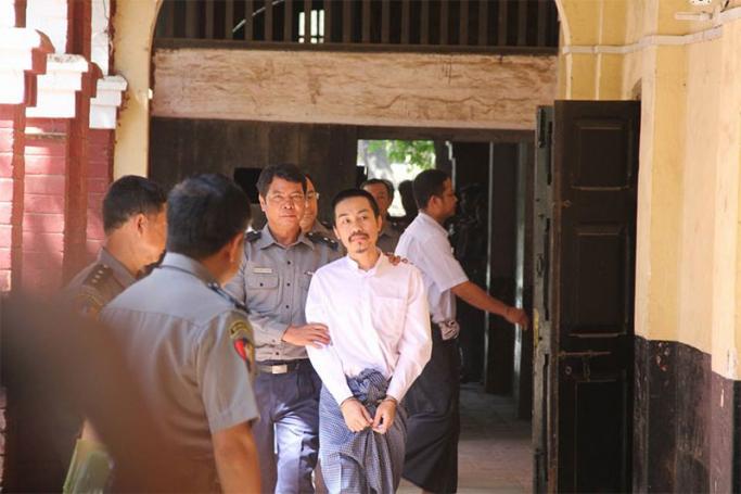 Zayar Phyo (R), suspect in the killing of Lawyer Ko Ni, is escorted by police as he arrives to the court in Yangon on 17 March 2017. Photo: Thura/Mizzima
 
