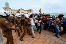 Government supporters and police clash outside the President's office in Colombo on May 9, 2022. Photo: AFP