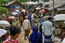 Rohingya refugees shop for vegetables and other essentials at a market area in Kutupalong refugee camp in Ukhia on August 7, 2022. Photo: Munir uz Zaman / AFP
