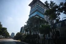 The Vantage Tower building (C), in which the main office of the Australian energy firm Woodside is located, is seen in Yangon on January 27, 2022, after the company announced its withdrawal from Myanmar. STR / AFP