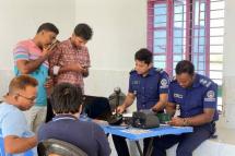 mage: Bangladesh immigration police personnel check the papers of delegation members, 05 May 2023. (Photo: EPA)