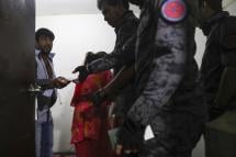 (File) An undocumented immigrant (L) with his family are questioned by immigration officers during a raid in Subang Jaya, outside of Kuala Lumpur, Malaysia, 29 July 2018. Photo: EPA