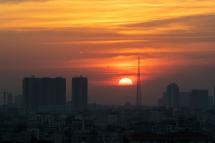 The sun sets behind the skyline of Yangon. Photo: Lynn Bo Bo/EPA