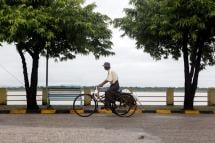 A man drives a trishaw at the strand road of Mawlamyine, Mon State, Myanmar. Photo: Lynn Bo Bo/EPA
