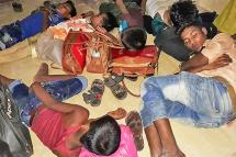 Rohingya refugees rest in a police station before being returned to the camps in Cox’s Bazar on May 15, 2019, after they were rescued from going on a sea voyage to Malaysia. Bangladeshi police shot dead two suspected Rohingya human traffickers, officials said May 15, after rescuing 103 refugees in two days about to make the perilous sea voyage to Malaysia. Photo: Suzauddin Rubel/AFP