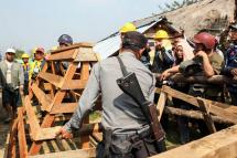 Police remove barricades after they decided to let members and supporters of a Christian based anti-narcotic group pass through a blocked area in northern Kachin State, Myanmar, 23 February 2016. Photo: Seng Mail/EPA
