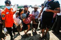 Volunteers move a wounded woman from a boat to an ambulance headed to Sittwe Hospital, in Sittwe, Rakhine State, Myanmar, 29 October 2020. Photo: Nyunt Win/EPA