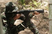 (File) In this undated file photo taken in May 2021, an anti-coup activist aims a weapon while undergoing basic military training at a camp of the Karen National Union (KNU), an ethnic rebel group, in Karen state. Photo: AFP