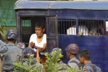 Aung Mhine San (C), student leader, gets out from a police vehicle at Township court in Letpadan, Bago division, Myanmar, 11 March 2015. Photo: Nyein Chan Naing/EPA
