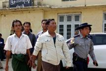 Bombing suspects Shwe Htet Aung (L, front), Than Shwe (R, front), Maung Oo Myint (L, back) and Naing Soe (R, back) are escorted out of court by a police officer in Sittwe, Rakhine State, Myanmar, 26 February 2018. Photo: Nyunt Win/EPA-EFE

