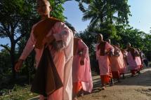 This photo taken on October 19, 2019 shows Buddhist nuns from the Mingalar Thaikti nunnery walking to collect alms in Yangon. Photo: Ye Aung Thu/AFP