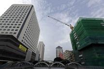 A crane set up at a construction site among tall buildings in downtown Yangon, Myanmar. Photo: Nyein Chan Naing/EPA
