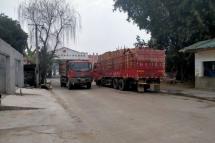 Trucks crossing the border from Myanmar to China with processed timber, March 2021
