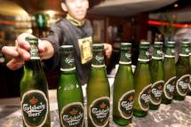 A bar employee lines up Danish Carlsberg beer bottles at a bar in Jakarta. Photo: EPA/WEDA
