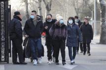 People wearing protective face masks walk near a temporary COVID-19 vaccine injection place outside the Chaoyang Park after they injected COVID-19 vaccines in Beijing, China, 03 January 2021. Photo: EPA