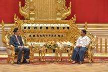 A handout photo made available by the Myanmar Military Information team shows Myanmar military chief Senior General Min Aung Hlaing (R) with Chinese Foreign Minister Qin Gang (L) during their meeting at the president house in Naypyi