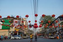 This photo taken on February 12, 2018 shows workers installing red lantern decorations in the streets of Yangon's Chinatown ahead of the Lunar New Year. Photo: Ye Aung Thu/AFP