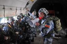 A People's Liberation Army (PLA) trainer encouraging soldiers as they participate in parachuting training in a transport plane in Hubei province, China, 17 January 2017. Photo: EPA
