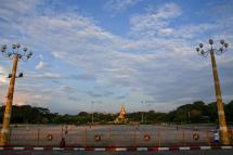 People enjoy the evening at a park near holy Shwedagon pagoda in Yangon. Photo: Lynn Bo Bo/EPA