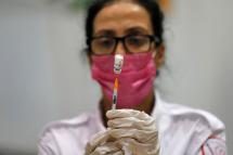 A paramedic with Israel's Magen David Adom medical service prepares to administer the third shot of the Pfizer-BioNTech Covid-19 vaccine. Photo: AFP