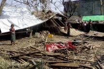 Rohingya people stand near damaged houses at the Thae Chaung Muslim internally displaced people (IDPs) camp near Sittwe, Rakhine State, Myanmar, 17 May 2023. Photo: EPA