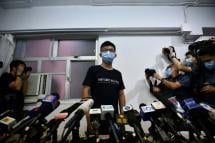 Hong Kong pro-democracy activist Joshua Wong (C) says 'resistance will continue' (AFP Photo/Anthony WALLACE)