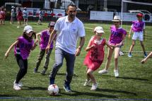 Former French football player Youri Djorkaeff plays with pupils at the Charles de Rochefoucauld school, his childhood school, in Lyon on June 4, 2019. Photo: Jean-Philippe Ksiazek/AFP