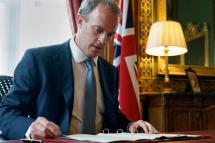 A handout image released by 10 Downing Street, shows Britain's Foreign Secretary Dominic Raab signing a letter to fellow MPs, in the Foreign & Commonwealth Office following the launch of new Human Rights Sanctions in London, Britain 06 July 2020. Photo: EPA