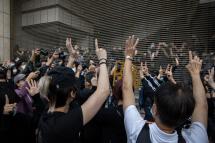 Pro-democracy activists gesture 'five demands, not one less' in support of arrested fellow activists outside the West KowloonDozens of Hong Kong  Court in Hong Kong, China, 01 March 2021. Photo: EPA