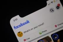 Facebook feed page is displayed on a smartphone. Photo: AFP