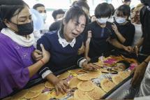 The mother (C-L) and the father (C-R) of Khant Nyar Hein, an eighteen-year-old medical student who was shot dead during a protest against the military coup, mourn over their son's body during a funeral service in Yangon, #Myanmar, 16 March 2021. Photo: EPA