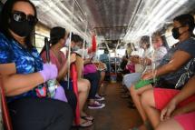 Passengers travel on a jeepney with seat dividers to ensure social distancing in Manila. Residents of Navotas, one of the poorest areas of the capital, will go back into lockdown following a spike in new coronavirus cases (AFP Photo/Ted ALJIBE) 