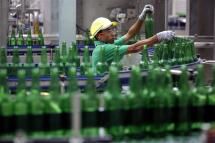 (File) A worker inspects empty bottles of Regal Seven beer at Heineken's newly-opened brewery near Yangon, Myanmar, 12 July 2015. Photo: EPA