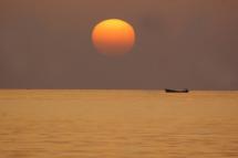 (File) The sun sets at the coast of the developing Gwadar district in southern Balochistan. Photo: EPA