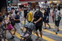 Pedestrians cross a street in the shopping district of Causeway Bay in Hong Kong, China. Photo: EPA