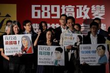 Pro-democracy lawmakers (L-R) "Long Hair" Leung Kwok-hung, Lau Siu-lai, Edward Yiu, and Nathan Law Kwun-chung hold banners during a rally in Hong Kong on December 11, 2016, against a crackdown on pro-democracy lawmakers and an electoral system skewed towards Beijing ahead of elections for a new city leader. Photo: AFP