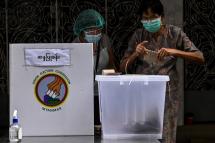 A woman votes at a polling station in Yangon on October 29, 2020, as advance voting in the country's elections began for elderly people. Photo: Ye Aung Thu/AFP