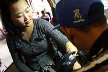 Tattooing taking place at the Human Rights Human Dignity International Film Festival in Yangon. Photo: Tara Lee
