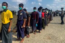 Released Rohingya prisoners wearing face masks amid concerns of the COVID-19 coronavirus pandemic arrive in Sittwe jetty in Rakhine State after being transported by military boat on April 20, 2020. Photo: AFP
