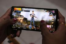 A woman plays PlayerUnknown's Battlegrounds (PUBG) online game on her mobile phone in New Delhi, India, 02 September 2020. Photo: EPA