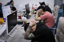 This picture taken on August 29, 2023 shows a group of Chinese nationals who were arrested during a police raid on suspicion of running an online love scam syndicate that ensnared hundreds of victims in China, at a building of the Kara Industrial Park in Batam, in Indonesia's Riau Islands province. Photo: AFP