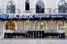   IBK Bank Myanmar employees pose for a photo after the bank received a banking license from Myanmar’s financial authorities, Wednesday at the bank’s headquarters in Yangon, Myanmar. Photo: Industrial Bank of Korea ...