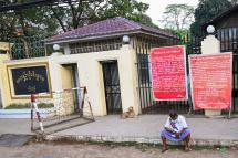 A man sits in front of Insein prison in Yangon on April 12, 2021, while waiting to visit inmates ahead of the long holiday stretch for the Myanmar New Year, also known as Thingyan, as the country remains in turmoil after the February military coup. Photo: AFP