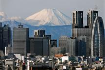 Japan's highest peak Mount Fuji is covered with snow and visible through Shinjuku skyscrapers in Tokyo, Japan. Photo: EPA