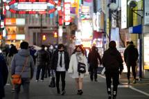 Pedestrians walk through an entertainment district street in Tokyo, Japan. Photo: EPA