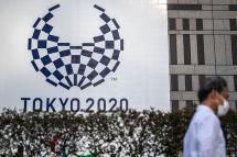 A man walks past a Tokyo 2020 Paralympic Games banner at the entrance to the Metropolitan Government Building in Tokyo on August 19, 2021. Photo: AFP