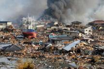 (FILE) - Burning houses and ships piled amidst Tsunami flood water in a mass of debris in Kisenuma city, Miyagi prefecture, Japan, 12 March 2011. Photo: EPA