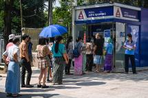  People queue as they wait to use the automated teller machines (ATM) of KBZ Bank in Yangon on April 7, 2021, amid strained banking operations due to the ongoing demonstrations by protesters against the February military coup. Photo: AFP