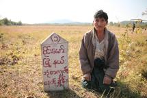 A Kachin farmer in Wai Maw township in Kachin State kneeling down on a plot of land confiscated from him by a company. (Photo: Thin Lei Win/Myanmar Now) 
